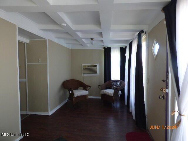 interior space featuring coffered ceiling, dark hardwood / wood-style flooring, and beam ceiling