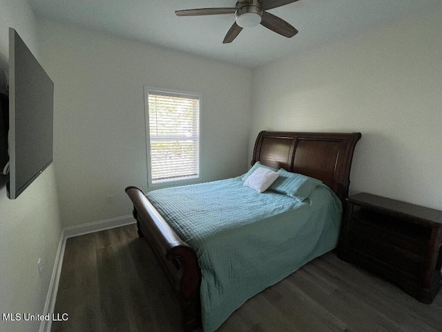 bedroom with ceiling fan and dark wood-type flooring