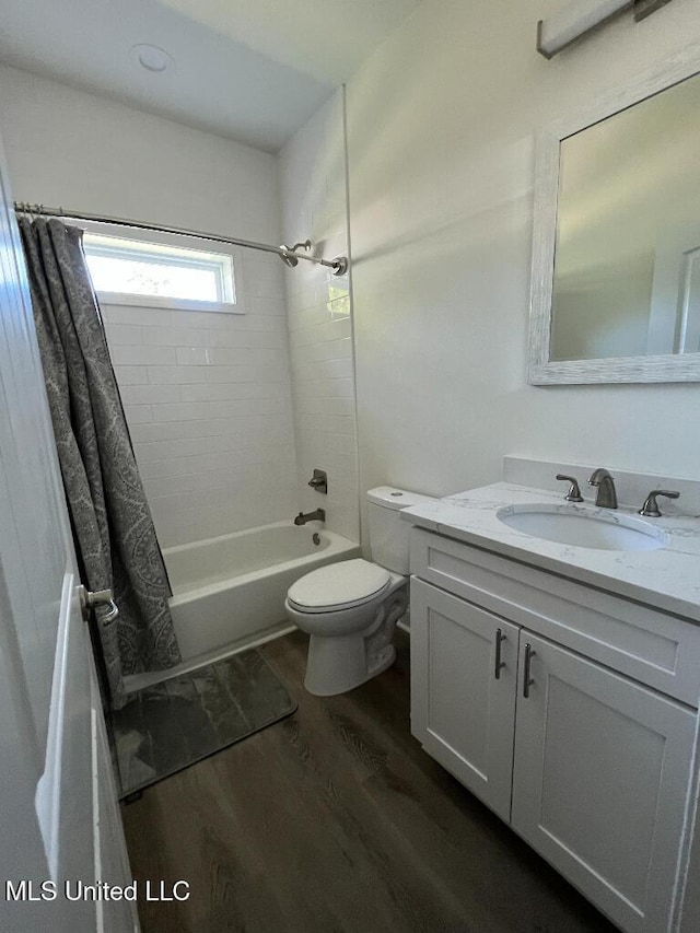 full bathroom with shower / tub combo, vanity, hardwood / wood-style flooring, and toilet