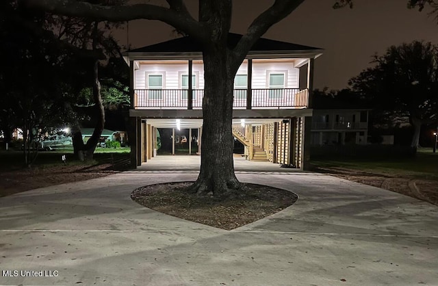 view of front of home featuring a balcony and a carport