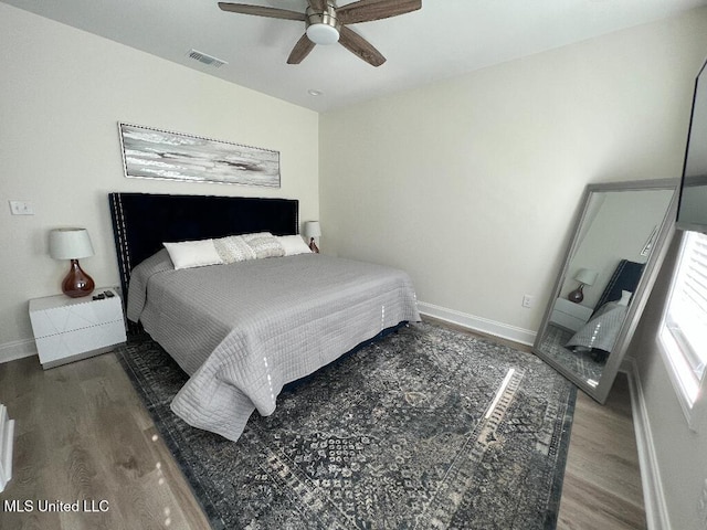 bedroom featuring ceiling fan and dark wood-type flooring