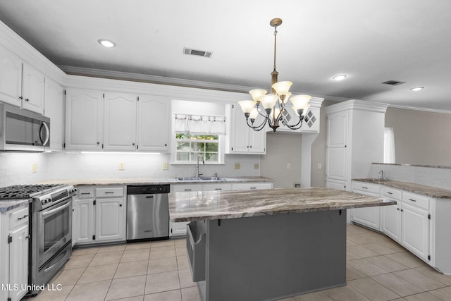 380 Green Acres Dr, Canton, MS 39046 - kitchen with stainless steel appliances, a chandelier, tasteful backsplash, light tile patterned floors, and ornamental molding