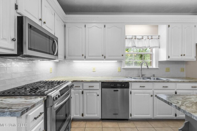 380 Green Acres Dr, Canton, MS 39046 - kitchen with stainless steel appliances, light tile patterned flooring, and white cabinets