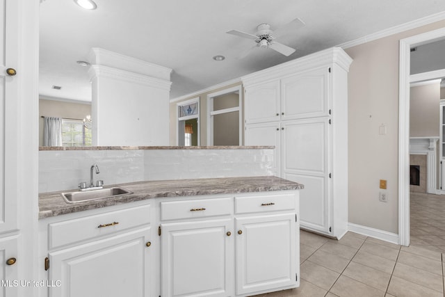 380 Green Acres Dr, Canton, MS 39046 - kitchen featuring ceiling fan, white cabinetry, ornamental molding, light tile patterned floors, and tasteful backsplash