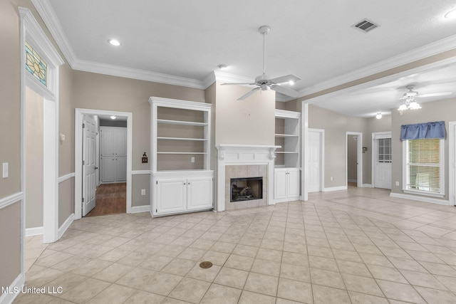 380 Green Acres Dr, Canton, MS 39046 - unfurnished living room with ceiling fan, ornamental molding, light tile patterned floors, a tiled fireplace, and built in shelves