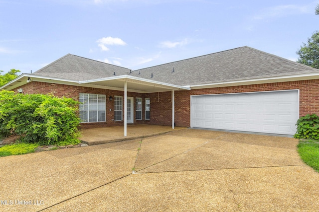 380 Green Acres Dr, Canton, MS 39046 - view of front of property featuring a shingled roof, concrete driveway, a garage, and brick siding