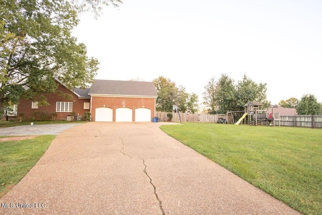 view of front facade featuring a playground, driveway, brick siding, a garage, and a shingled roof