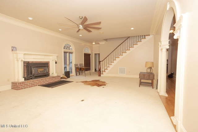 unfurnished living room with decorative columns, crown molding, light wood-type flooring, and ceiling fan