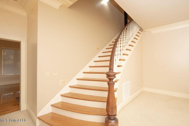 stairs featuring ornamental molding, carpet floors, and baseboards
