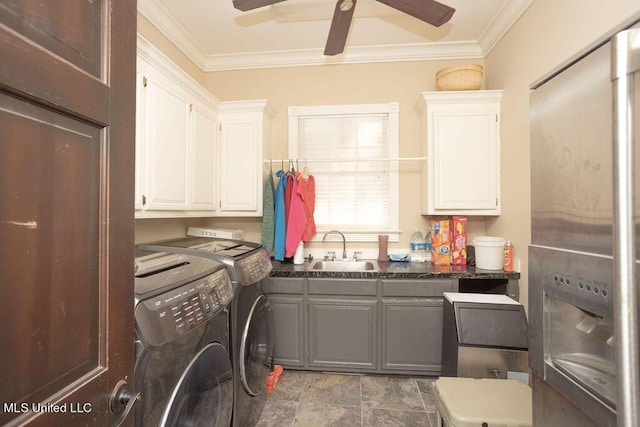 laundry room with independent washer and dryer, cabinet space, crown molding, a ceiling fan, and stone finish flooring
