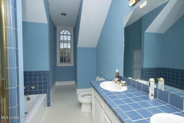 full bathroom with toilet, a garden tub, double vanity, tile patterned flooring, and vaulted ceiling