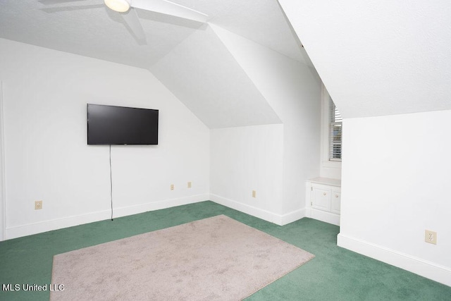 additional living space featuring carpet floors, lofted ceiling, ceiling fan, and baseboards