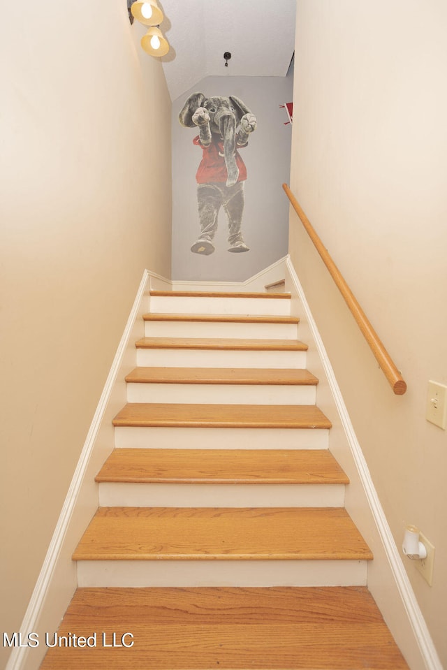 stairs featuring lofted ceiling