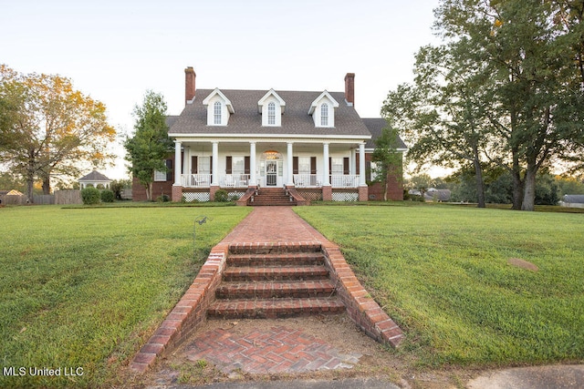 cape cod home with a porch and a front yard