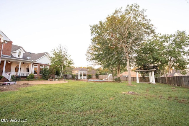 view of yard with a ceiling fan, a gazebo, and a patio