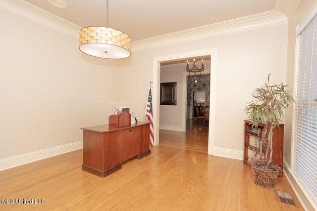 hallway featuring ornamental molding, light wood-style floors, baseboards, and a chandelier