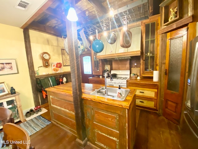 kitchen featuring white gas stove, butcher block counters, sink, and dark hardwood / wood-style flooring