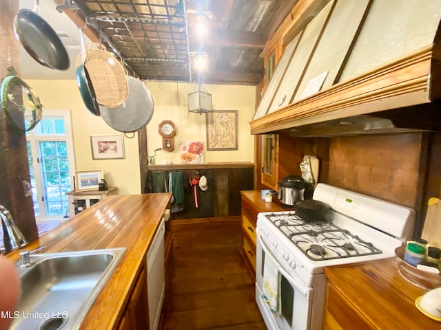 kitchen with custom exhaust hood, wood counters, dark wood-type flooring, sink, and white appliances