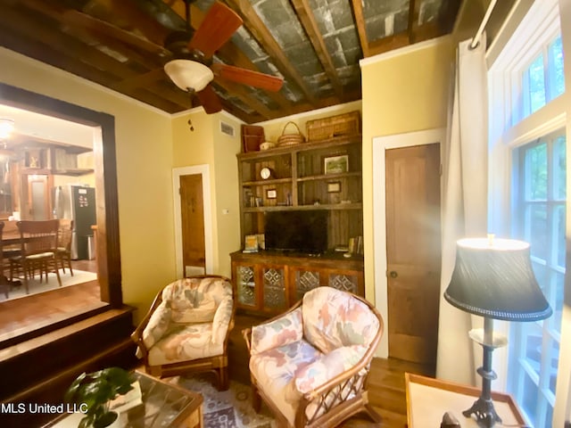 living area with hardwood / wood-style floors and ceiling fan