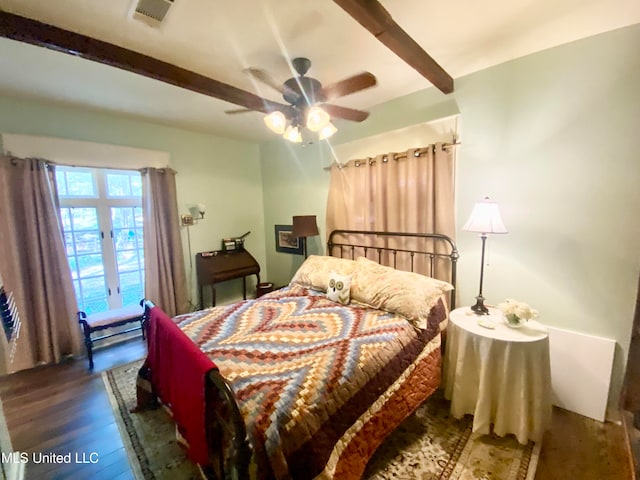 bedroom with beam ceiling, dark wood-type flooring, and ceiling fan