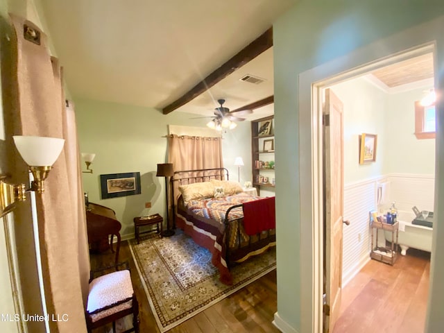 bedroom with ceiling fan, hardwood / wood-style flooring, and beam ceiling