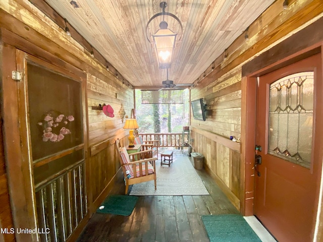 interior space with wood walls, wooden ceiling, and dark hardwood / wood-style floors