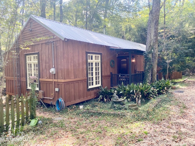 view of home's exterior with an outbuilding