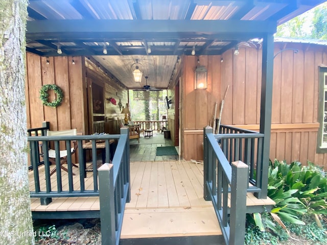 wooden deck featuring ceiling fan