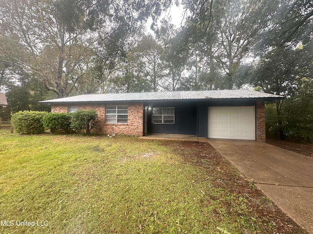 single story home with a garage and a front lawn