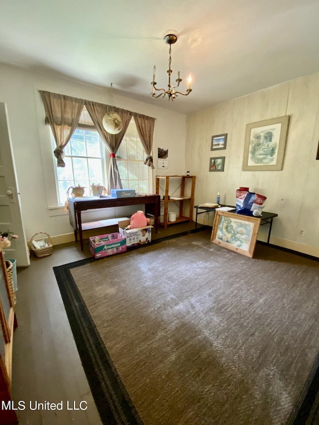 1903 Circle Dr, Picayune, MS 39466 - living area featuring baseboards, wood finished floors, and an inviting chandelier