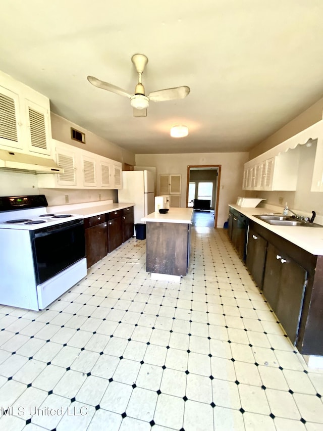 1903 Circle Dr, Picayune, MS 39466 - kitchen featuring light floors, dark brown cabinets, white appliances, and a sink