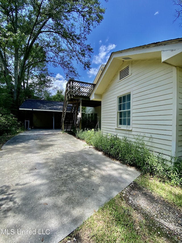 1903 Circle Dr, Picayune, MS 39466 - view of side of home featuring a carport and driveway