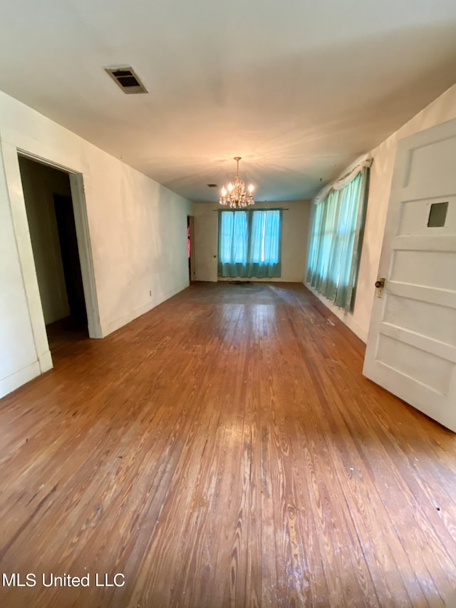 1903 Circle Dr, Picayune, MS 39466 - unfurnished room featuring hardwood / wood-style floors, baseboards, visible vents, and a notable chandelier