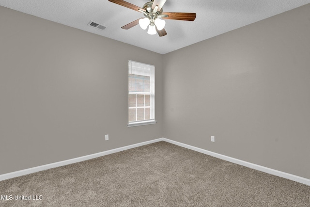 carpeted spare room with ceiling fan and a textured ceiling