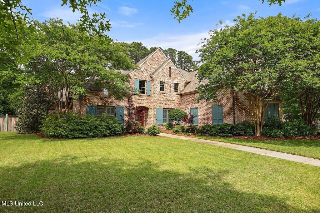 112 Fenwick Cir, Madison, MS 39110 - traditional-style house with brick siding, a front lawn, and fence