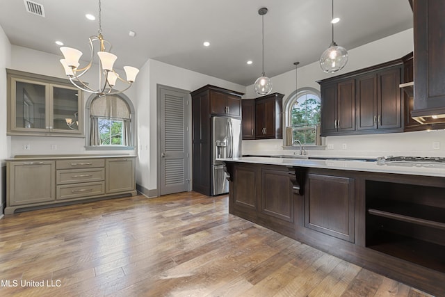 31 Poplar Cir, Gulfport, MS 39507 - kitchen featuring appliances with stainless steel finishes, light countertops, dark brown cabinets, healthy amount of natural light, and recessed lighting