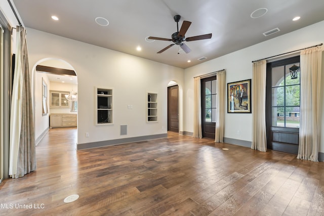 31 Poplar Cir, Gulfport, MS 39507 - unfurnished living room featuring arched walkways, a ceiling fan, wood-type flooring, recessed lighting, and built in features