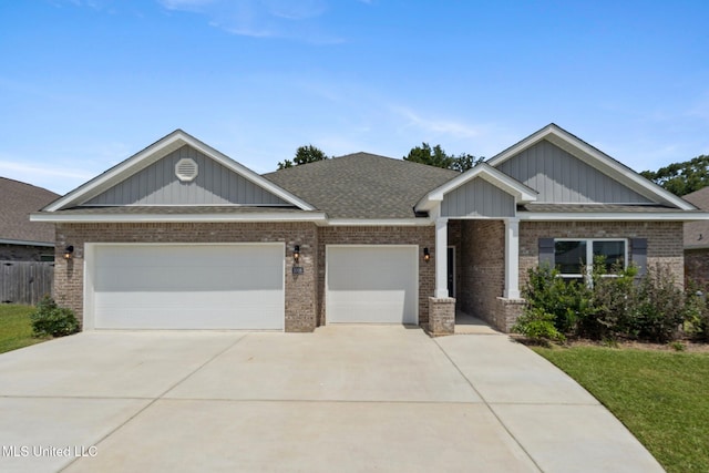 5006 Sand Dollar Dr, Long Beach, MS 39560 - craftsman house with brick siding, concrete driveway, an attached garage, and a shingled roof