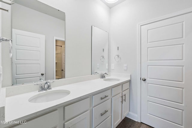 5006 Sand Dollar Dr, Long Beach, MS 39560 - bathroom featuring double vanity and wood finished floors