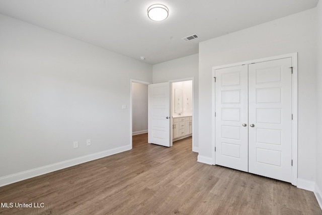 5006 Sand Dollar Dr, Long Beach, MS 39560 - unfurnished bedroom with light wood finished floors, a closet, and ensuite bathroom