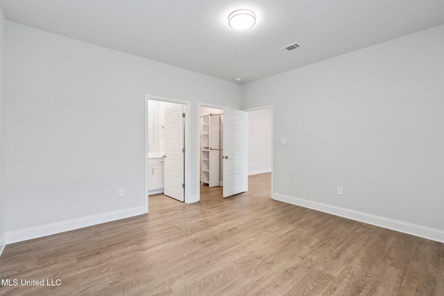 5006 Sand Dollar Dr, Long Beach, MS 39560 - unfurnished bedroom with a spacious closet, light wood finished floors, and a closet