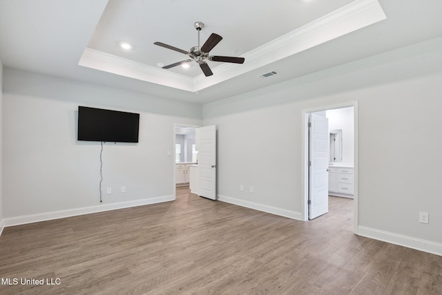 5006 Sand Dollar Dr, Long Beach, MS 39560 - unfurnished bedroom with a tray ceiling, ornamental molding, light wood-style floors, ensuite bathroom, and recessed lighting