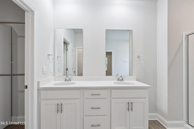 5006 Sand Dollar Dr, Long Beach, MS 39560 - full bath with double vanity, an enclosed shower, and wood finished floors