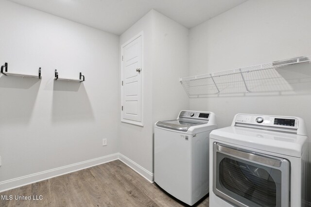 5006 Sand Dollar Dr, Long Beach, MS 39560 - laundry area featuring independent washer and dryer and light wood finished floors