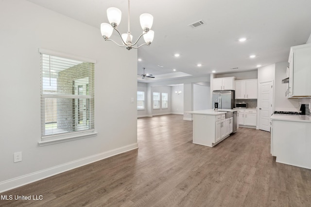 5006 Sand Dollar Dr, Long Beach, MS 39560 - kitchen with stainless steel appliances, open floor plan, light wood-type flooring, light countertops, and recessed lighting