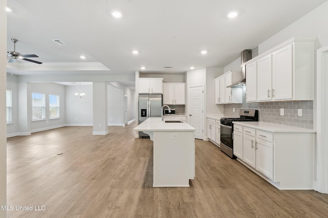 5006 Sand Dollar Dr, Long Beach, MS 39560 - kitchen featuring stainless steel appliances, backsplash, open floor plan, a raised ceiling, and ceiling fan