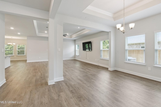 5006 Sand Dollar Dr, Long Beach, MS 39560 - unfurnished living room featuring a raised ceiling, a chandelier, crown molding, wood finished floors, and recessed lighting