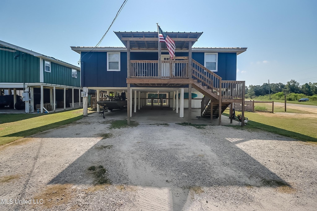 rear view of house featuring a yard and a carport