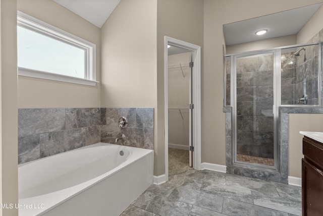 bathroom featuring vanity, lofted ceiling, and shower with separate bathtub