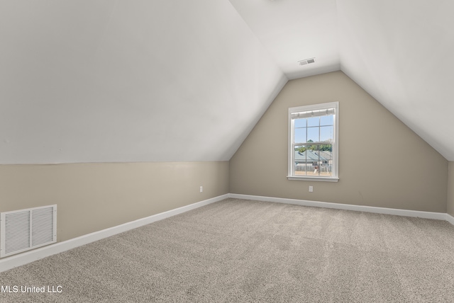 bonus room with carpet flooring and lofted ceiling